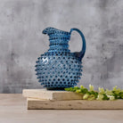 Hobnail Glass Pitcher in Midnight Blue on a table at Addison West