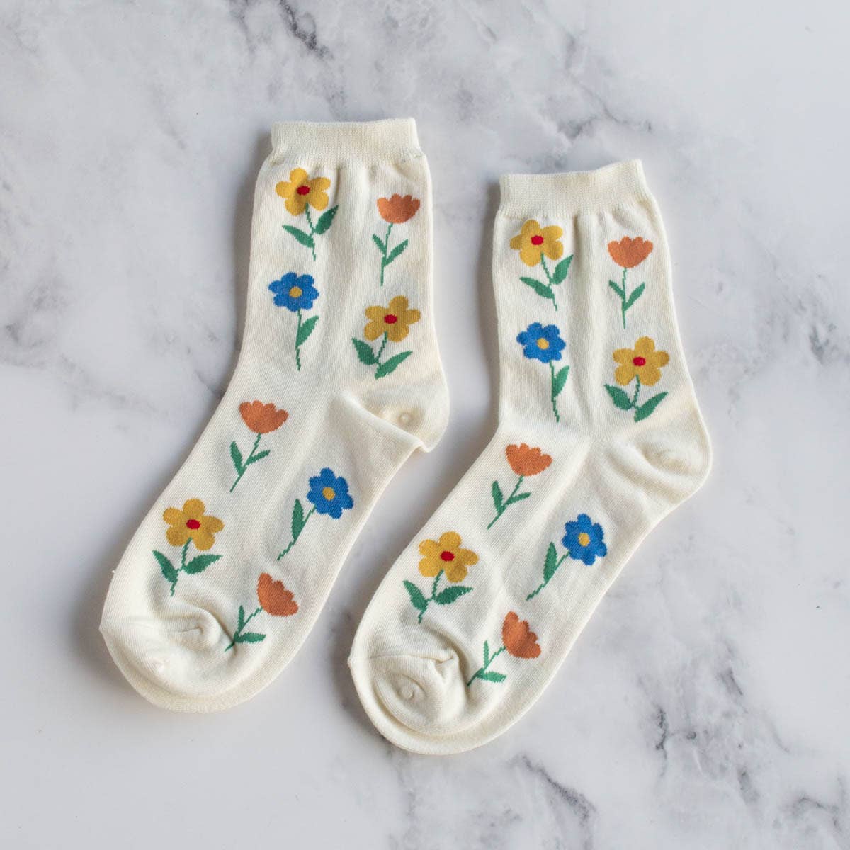 Favorite Flower Socks in Cream on a table at Addison West