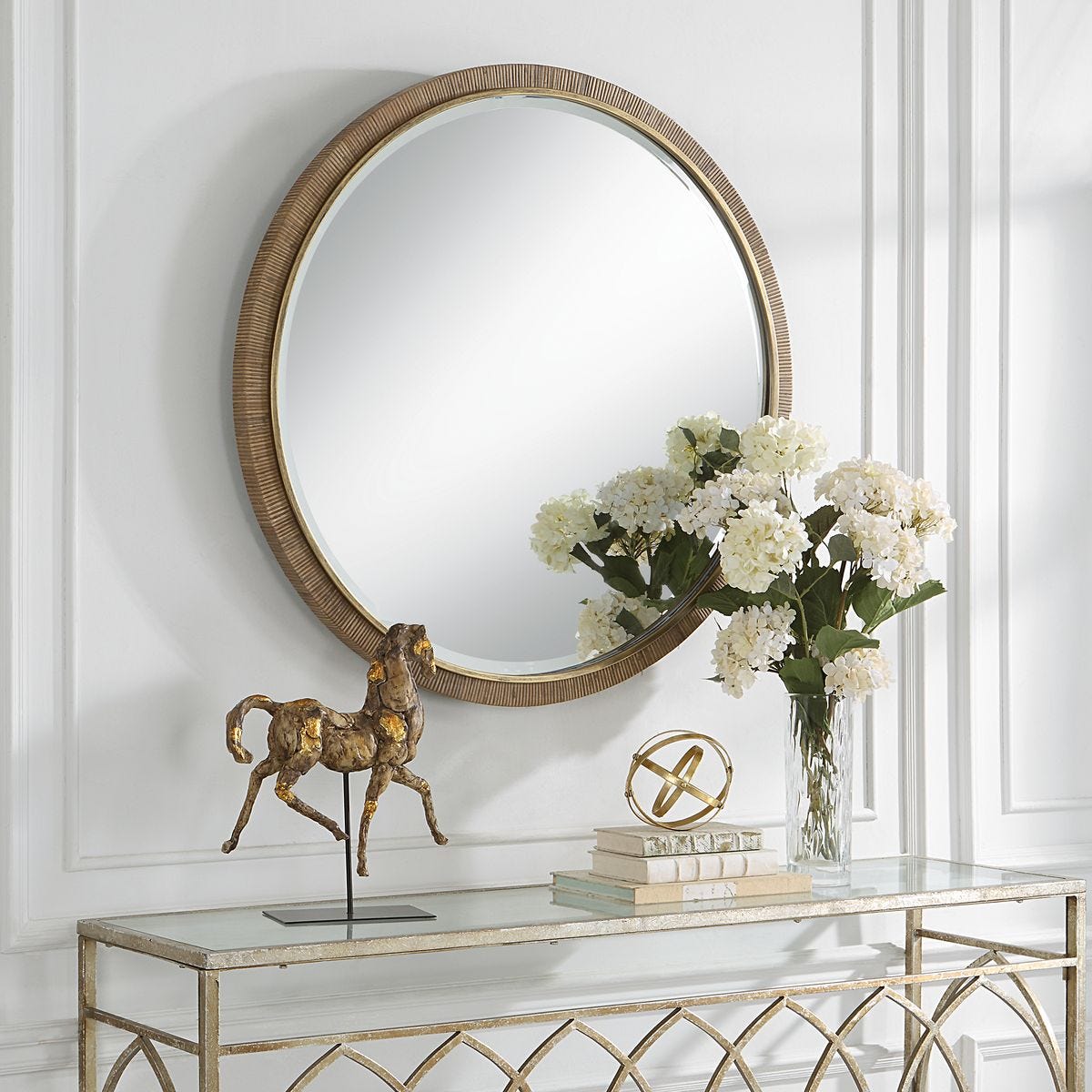 Parnell Round Accent Mirror on a white wall above a table at Addison West