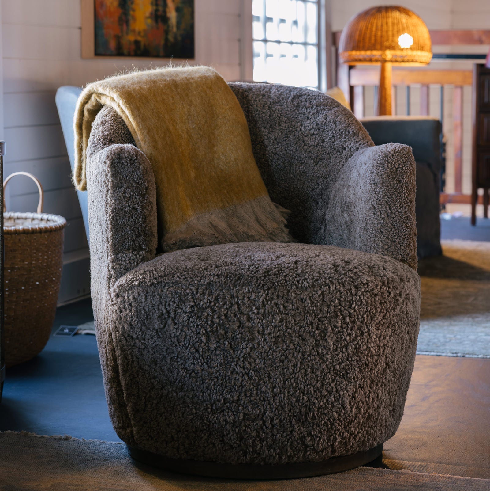 Four Hands Aurora Swivel Chair in Taupe Shearling in a living room at Addison West