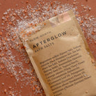 Afterglow Bath Salts in an orange background at Addison West