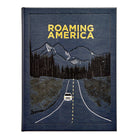 Book titled 'Roaming America' in leather by graphic image with a road and mountain design on the cover.