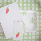 Strawberry Notepad on a table at Addison West