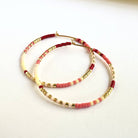 Ocean Breakup Large Beaded Hoop Earrings in Blood Orange on white background at the Addison West.