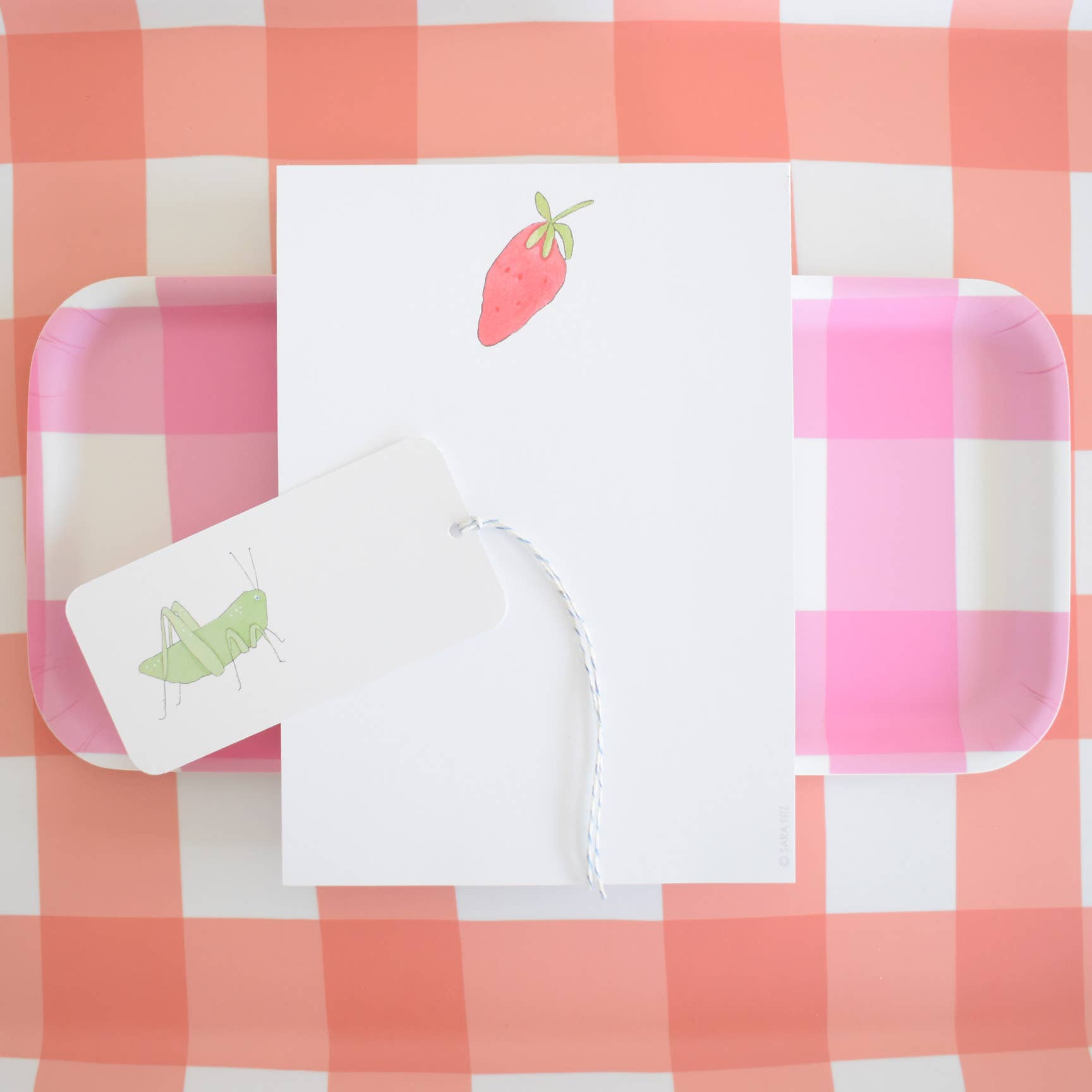 Strawberry Notepad on a table at Addison West