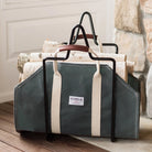 Steele Canvas and Leather Wood Carrier in Forest Green next to a fireplace at Addison West
