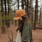 Barn Owl Corduroy Hat in Amber on a model outside at Addison West