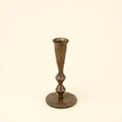 Bronze candlestick on a beige background