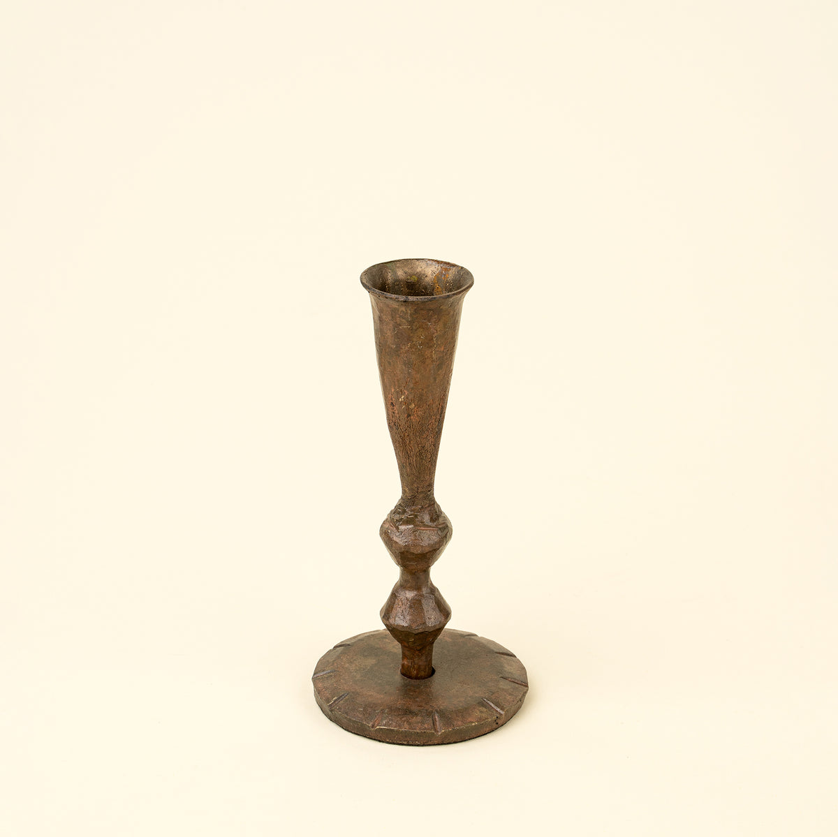 Bronze candlestick on a beige background