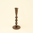 Bronze candlestick on a beige background