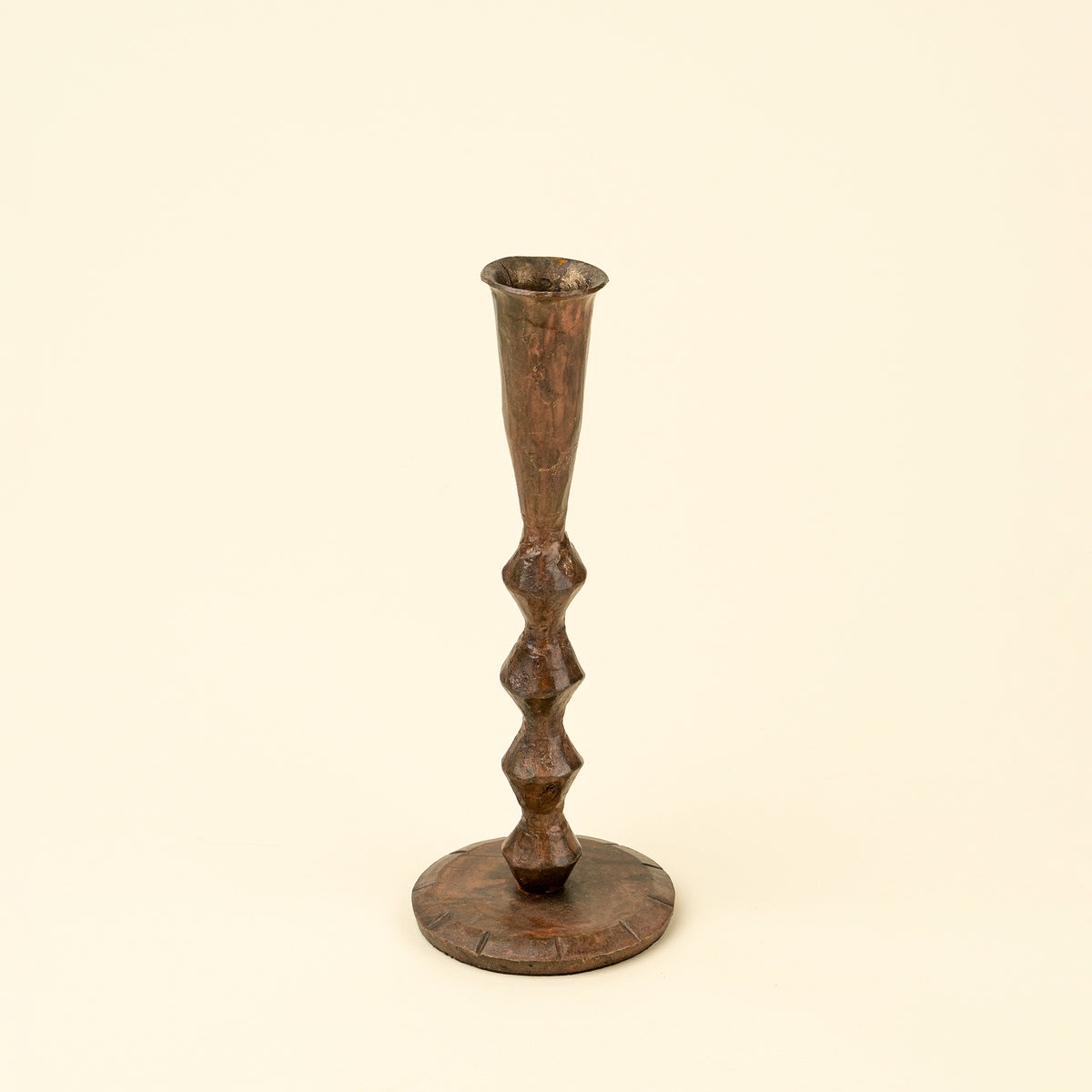Bronze candlestick on a beige background