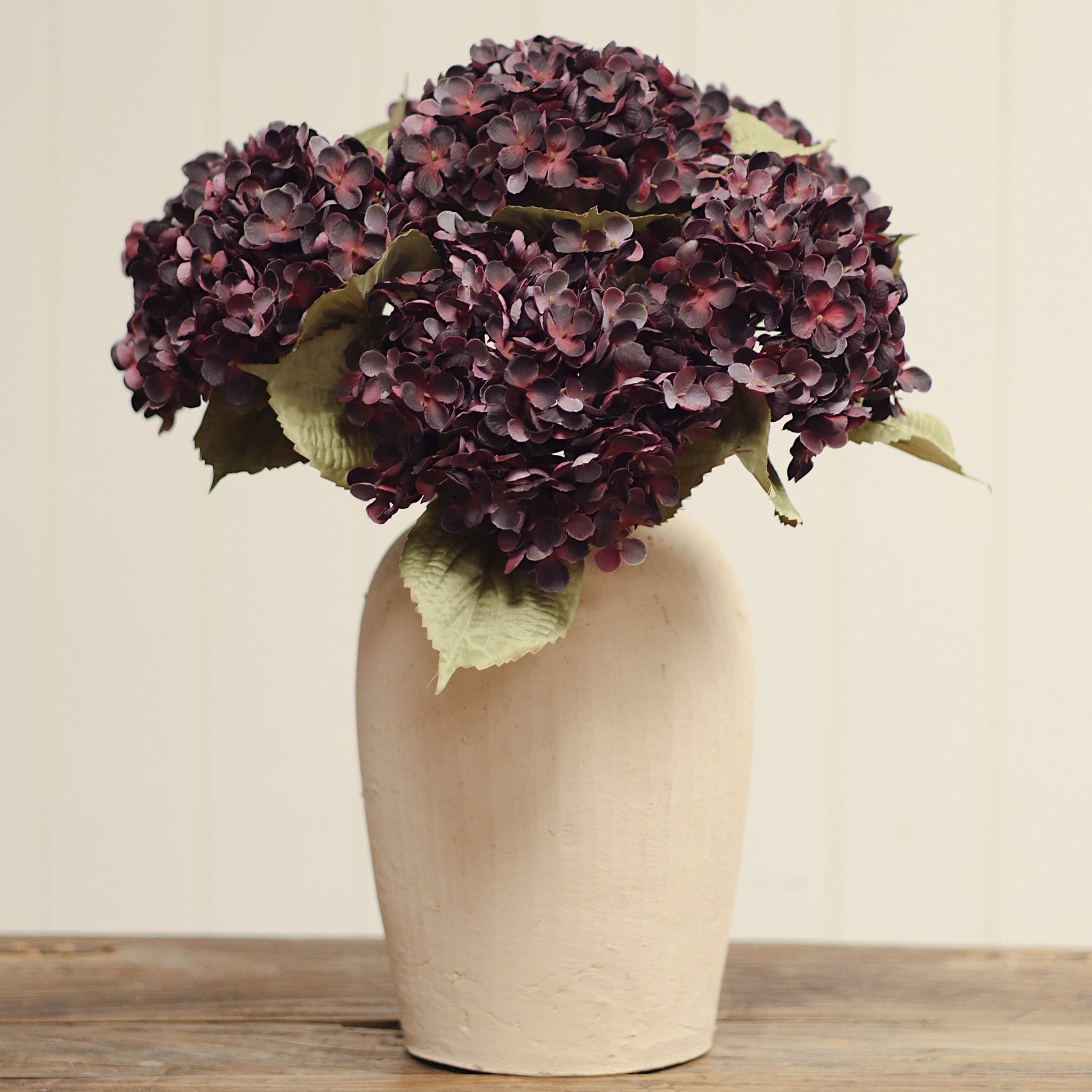 Heirloom Hydrangea Stem in Deep Purple on a beige background at Addison West