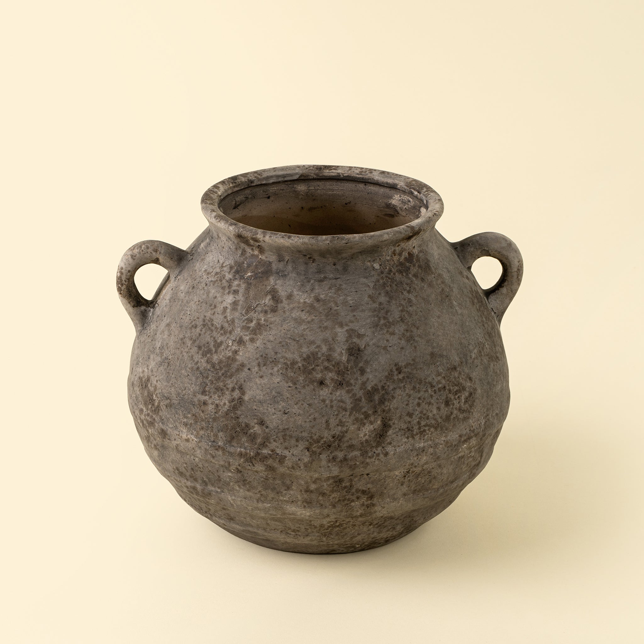Small Artifact Stoneware Vase on a beige background at Addison West