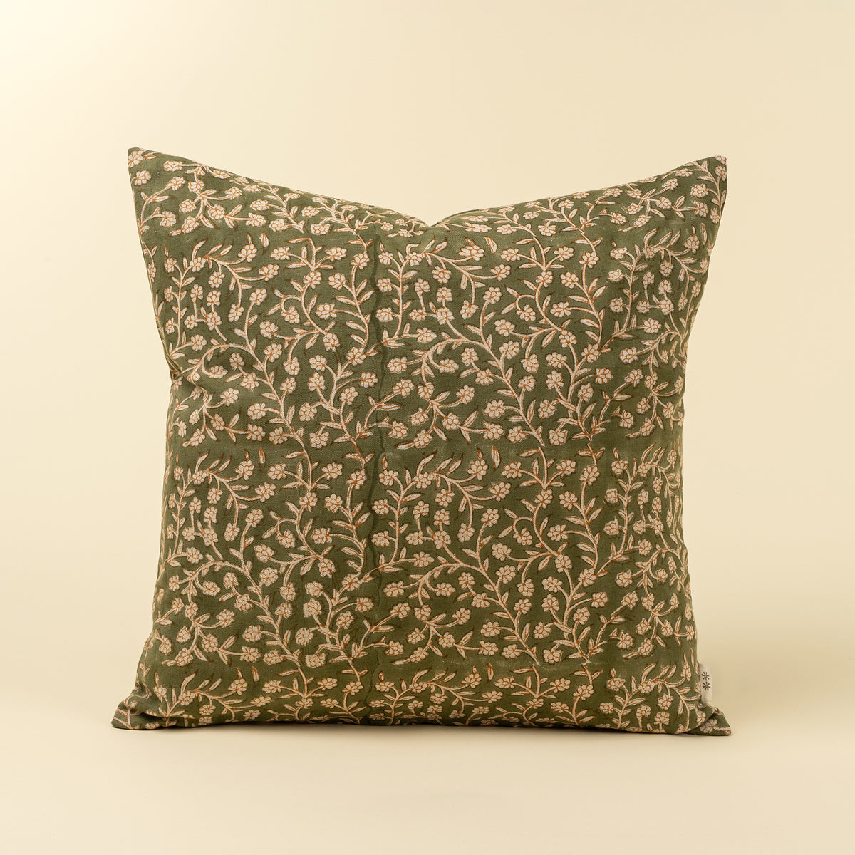 Decorative pillow with floral pattern on a beige background