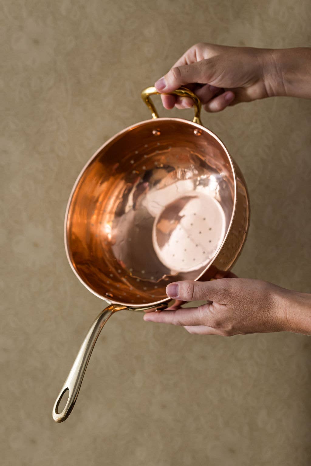Galley and Fenn Copper Colander on a beige background at Addison West