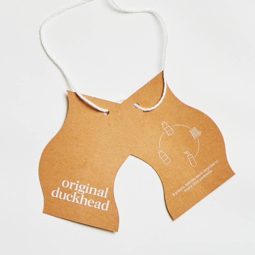 Tags for Original Duckhead Navy Eco-Friendly Umbrella on a white background at Addison West