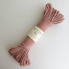 Pink rope with a label on a light gray background