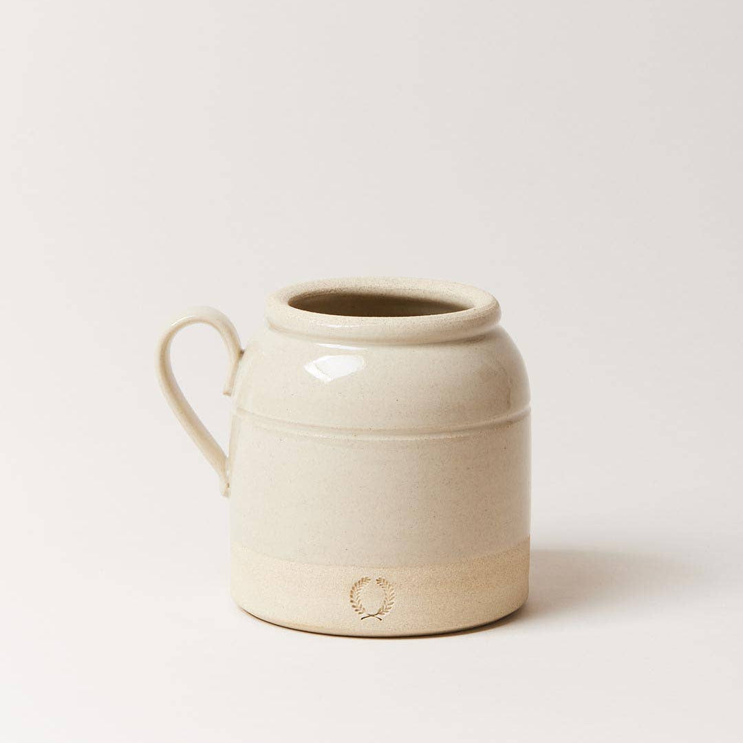 Beige ceramic mug on a light beige background