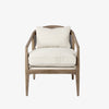 Armchair with light brown stain and sloped arms and cane back and light beige cushions on a white background