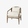 Armchair with light brown stain and sloped arms and cane back and light beige cushions on a white background