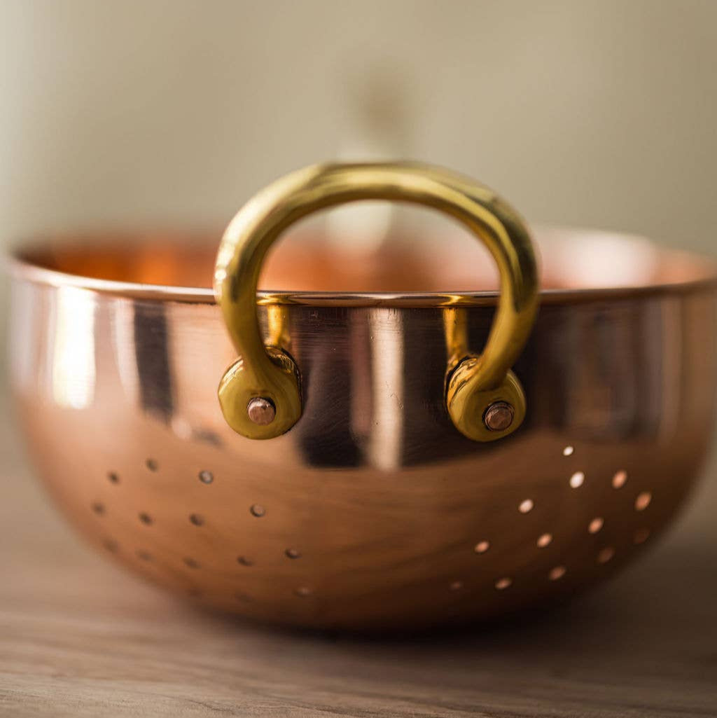 Galley and Fenn Copper Colander on a wood table at Addison West