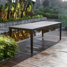 Porter Indoor–Outdoor Dining Table on a patio at Addison West