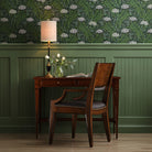 Marseille Writing Table in Bordeaux Finish in a green room at Addison West