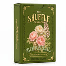 Shuffle club brand botantical playing cards in a green box with flowers on the front on a white background