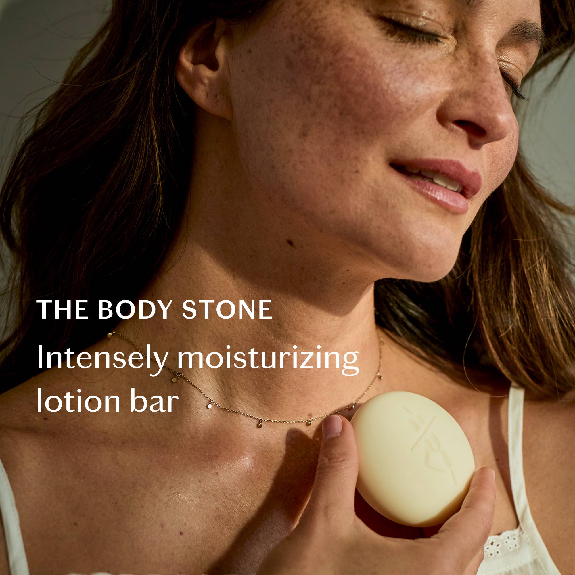 Tonka Bean & Coconut Deep Moisturizing Lotion Bar held by a model at Addison West