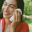 Ursa Major Essential Face Wipes held by a model at Addison West