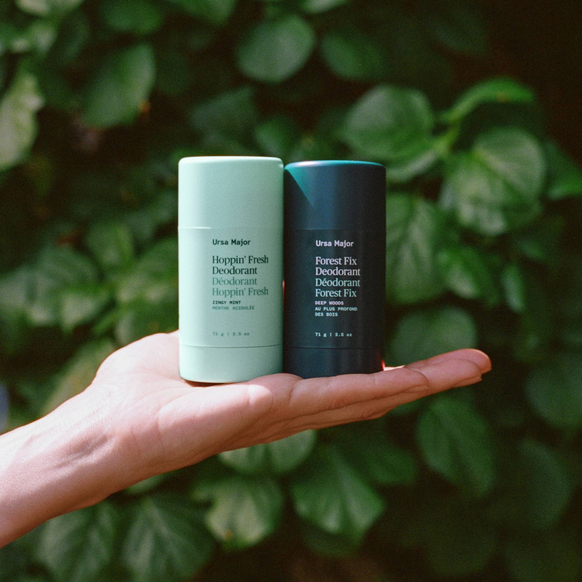 Ursa Major Forest Fix Deodorant held by a model outside at Addison West