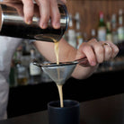Harrison Stainless Steel Mesh Cocktail Strainer being used by a bartender at Addison West