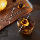 Harrison Reusable Stainless Steel Cocktail Picks on a table at Addison West