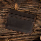 Leather Card Holder Wallet in Dark Brown on a table at Addison West