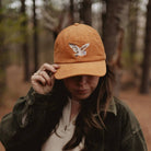 Barn Owl Corduroy Hat in Amber on a model outside at Addison West