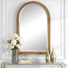 Capridge Arch Accent Mirror on a white wall above a table at Addison West