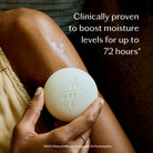Tonka Bean & Coconut Deep Moisturizing Lotion Bar held by a model at Addison West