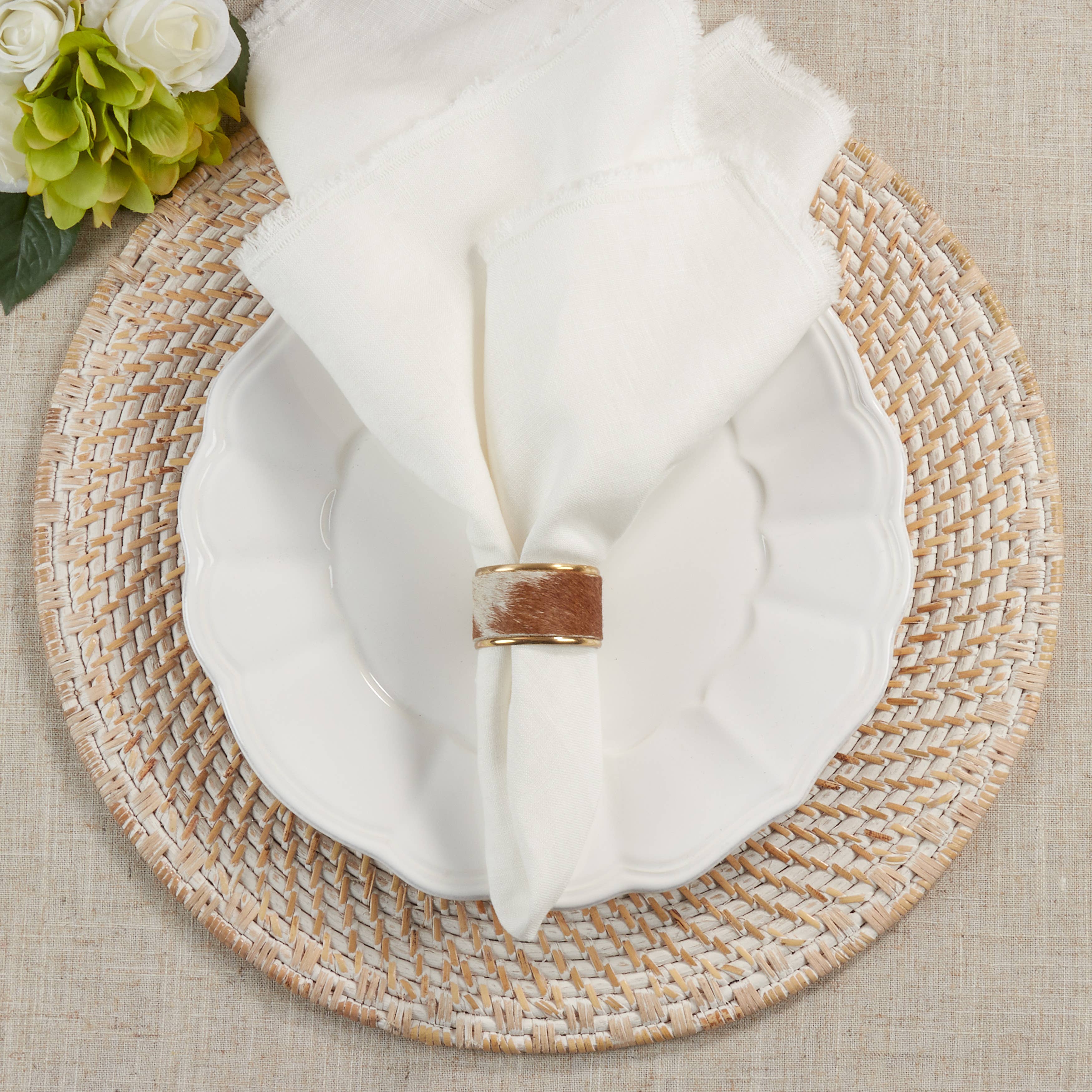Cow Hide Napkin Rings, Set of 4 on a table at Addison West