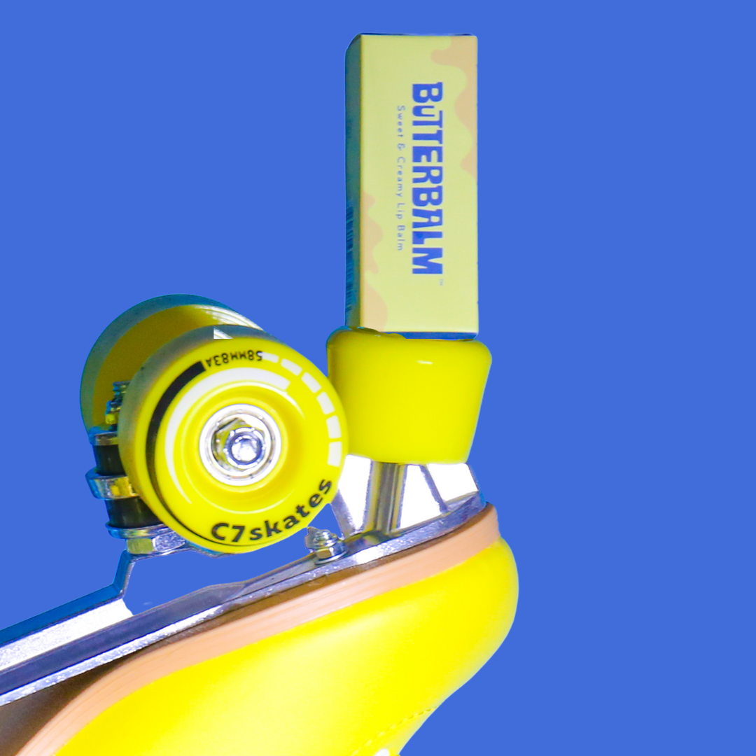 ButterBalm Original Sweet Cream Lip Balm on a blue background at Addison West