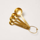 Stowe Measuring Spoons in Gold on a white background at Addison West