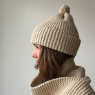 Knitting Craft Kit: Classic Pom Beanie in Sand on a beige background at Addison West