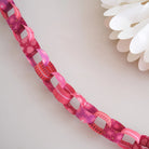 East End Press Pink & Red Paper Chain Kit on a white wall at Addison West