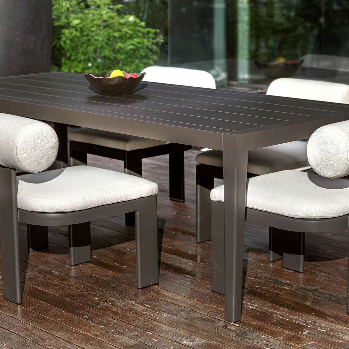 Porter Indoor–Outdoor Dining Table on a patio at Addison West