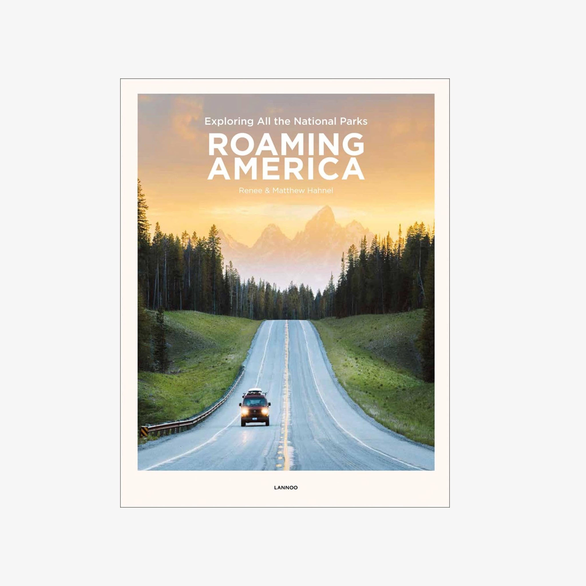 Front cover of Roaming America: Exploring All the National Parks with a photo of a truck driving down a long road with mountains in the background