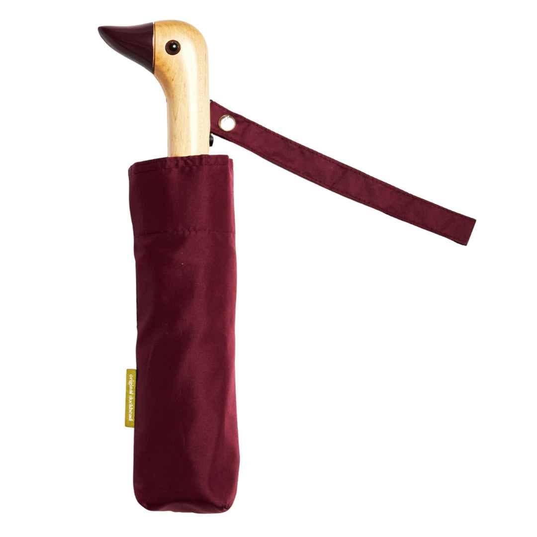 Compact umbrella with duck handle in a burgundy case on a white background