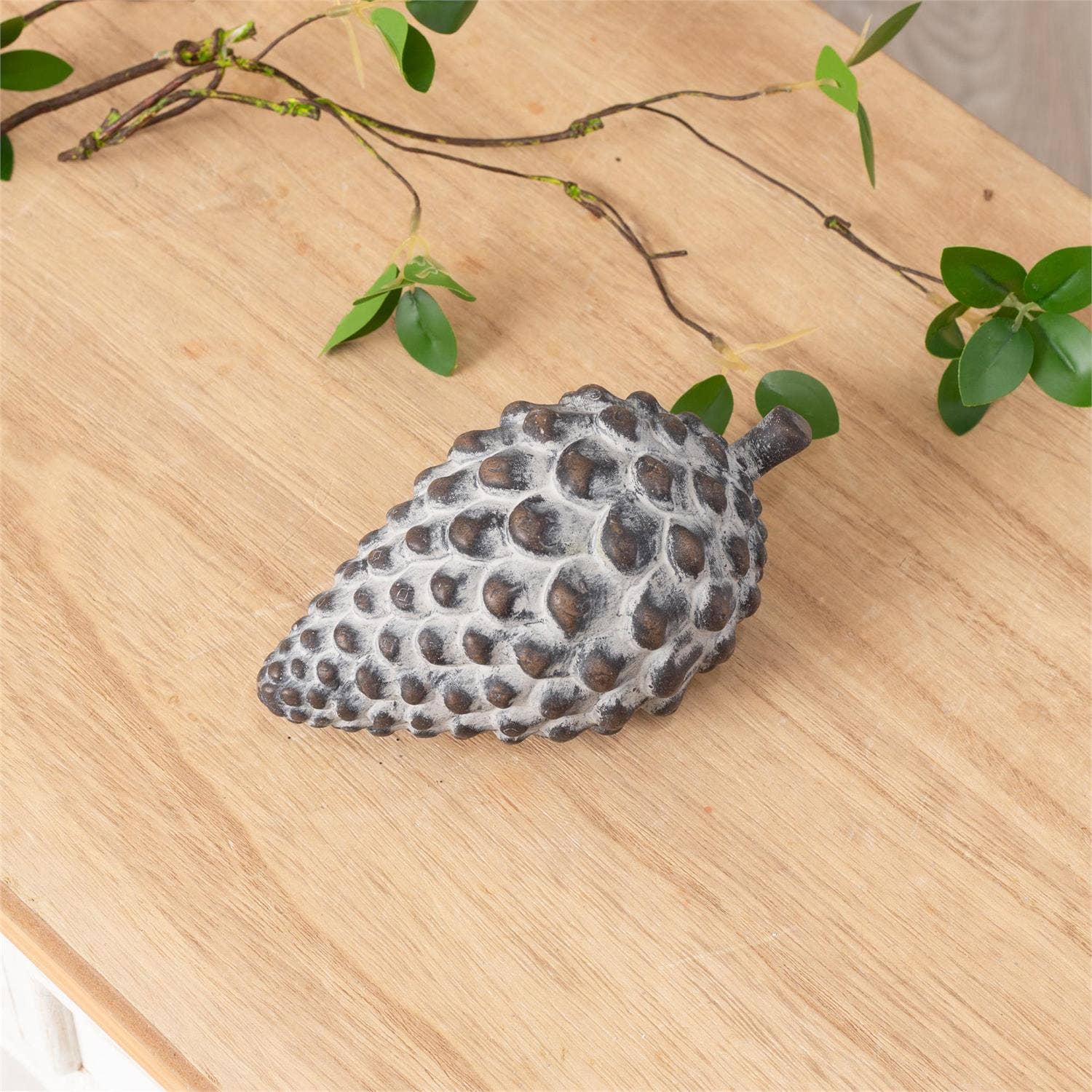 Cement Pinecone on a table  at Addison West
