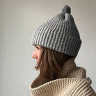 Knitting Craft Kit: Classic Pom Beanie in Pebbled Beach on a beige background at Addison West