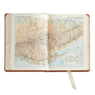 The Traveler's Atlas Cognac Leather on white background at Addison West.