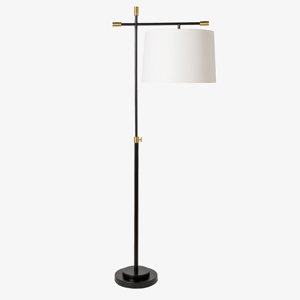 Surya Aberdeen floor lamp with black stand and stem and brass accents and a white linen shade on a white background