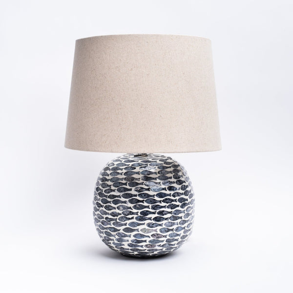 Round table lamp with inlay fish pattern and linen shade on a white background from Addison West